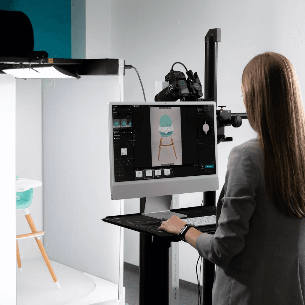 Operator working at an Orbitvu photography workstation