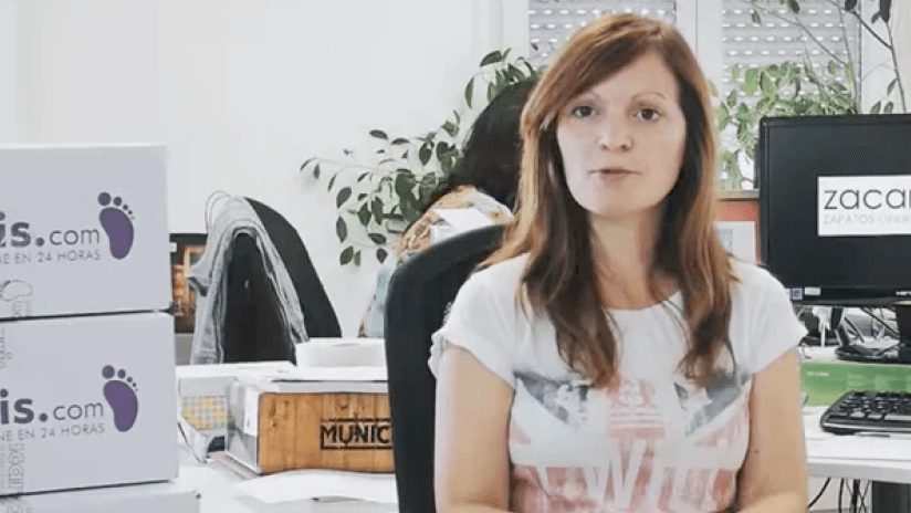 Woman in office setting speaking to camera