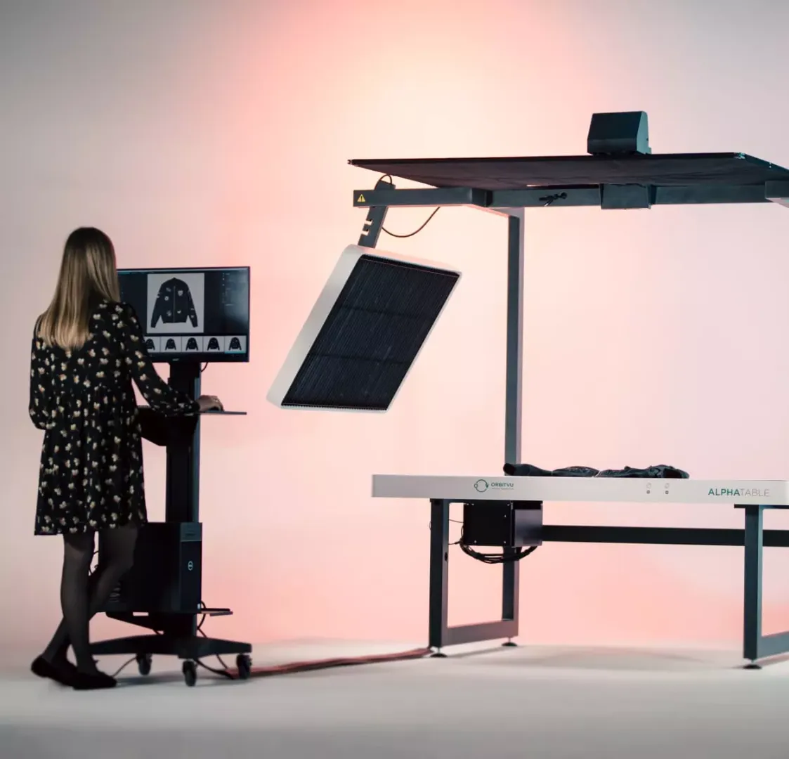 Operating automated flat lay clothing photography system