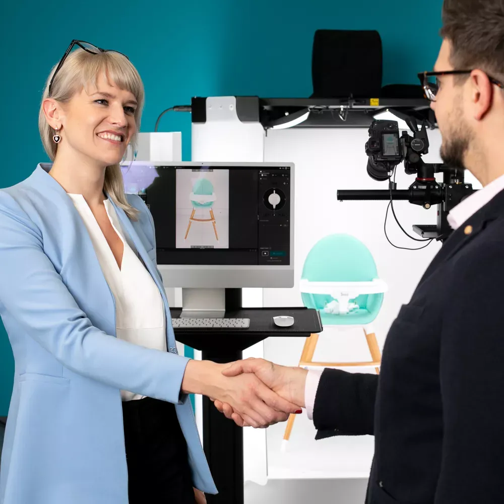 Two people shaking hands near a photo studio